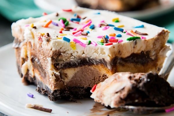 slice of ice cream cake on a white plate with a fork