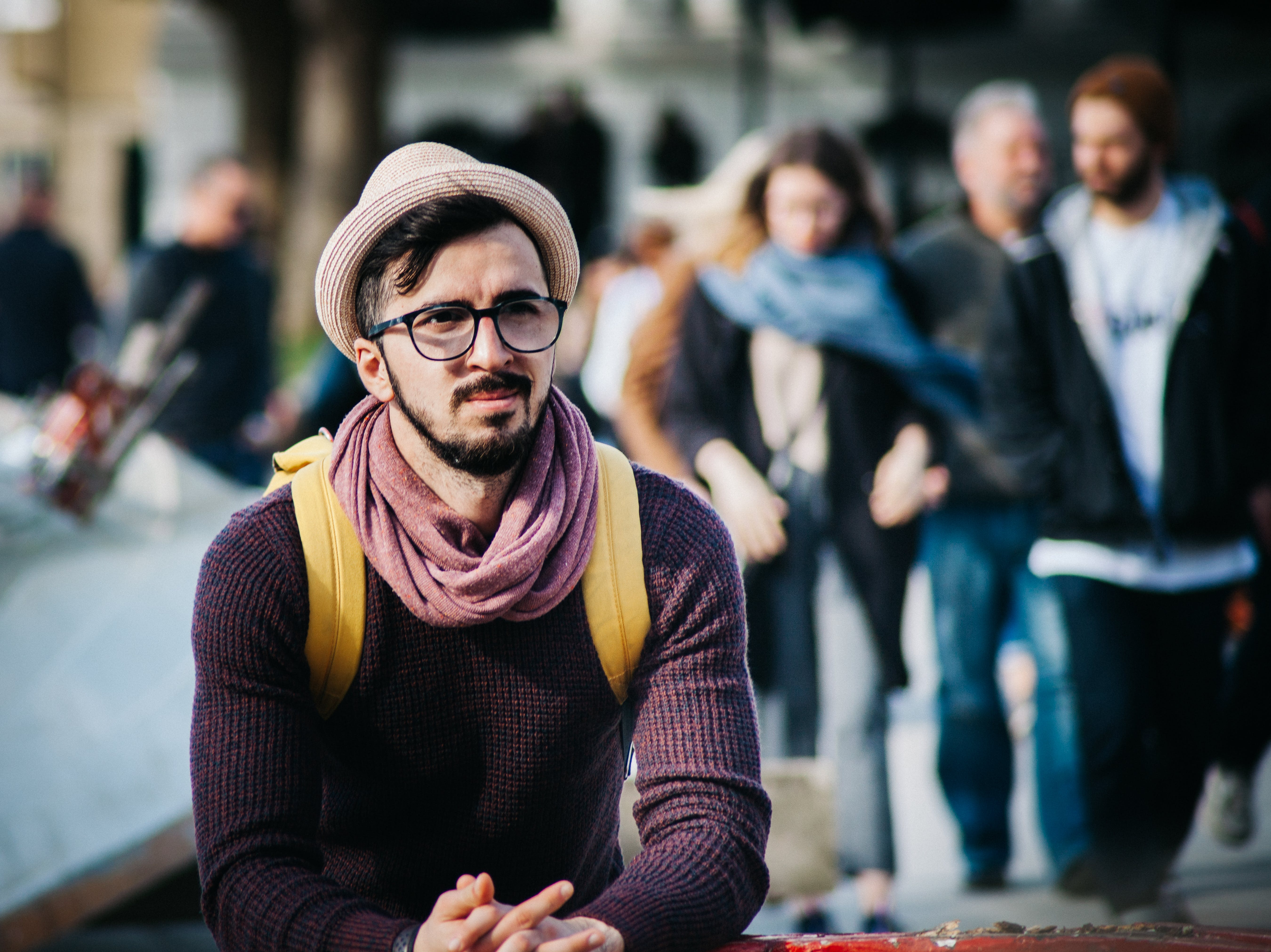 man sitting alone in a crowd