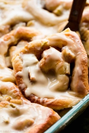 zoomed in image of apple cinnamon rolls in a glass baking dish