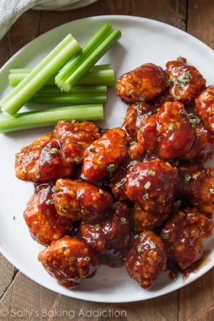 baked honey bbq popcorn chicken on a white plate