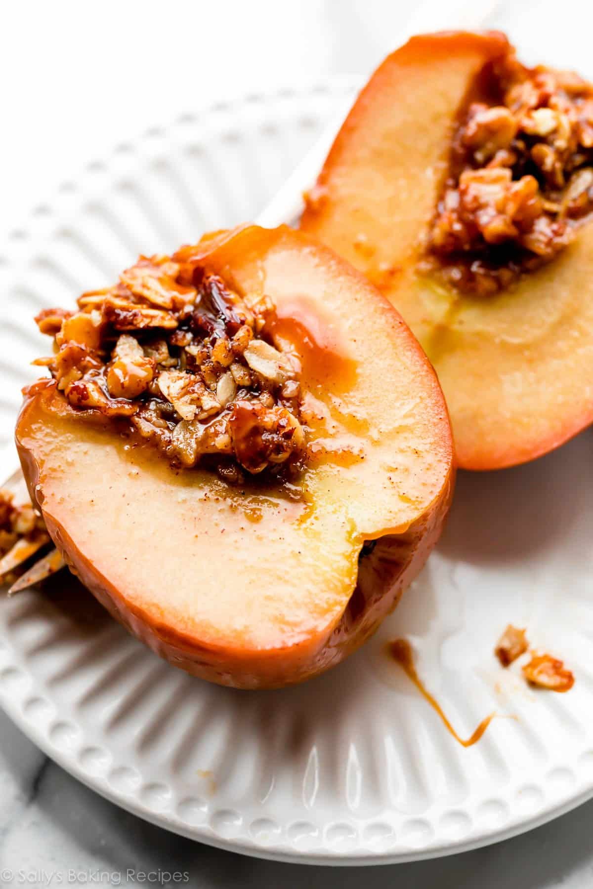 baked apple cut in half with brown sugar oat filling inside.