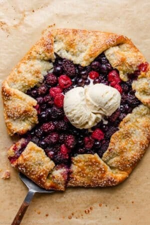 mixed berry galette with slice being removed.