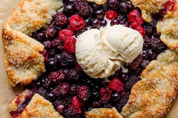 mixed berry galette with slice being removed.