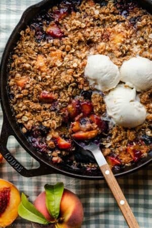 brown butter blueberry peach crisp in cast iron skillet.