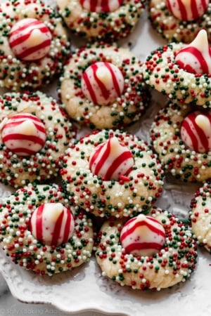 candy cane kiss sugar cookies arranged on white plate.