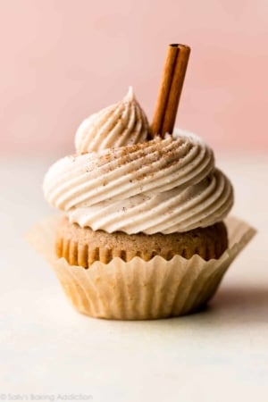 chai latte cupcake with a cinnamon stick garnish