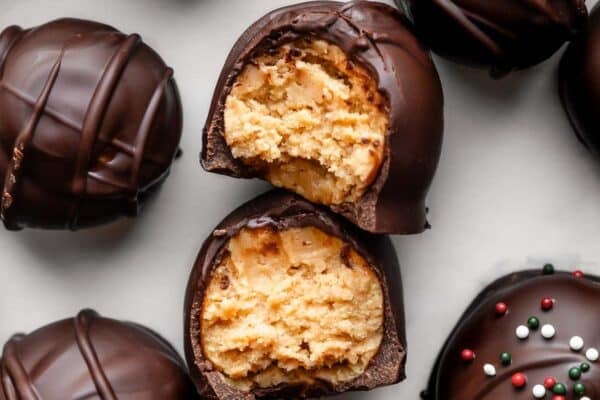 overhead photo of chocolate-covered peanut butter balls with sprinkles on top.