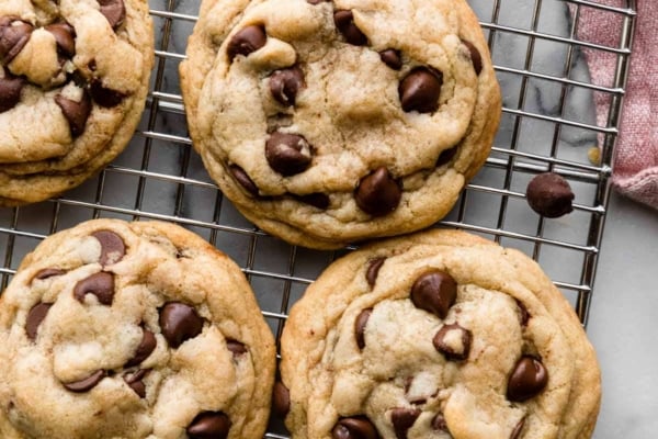 6 chocolate chip cookies on silver wire cooling rack