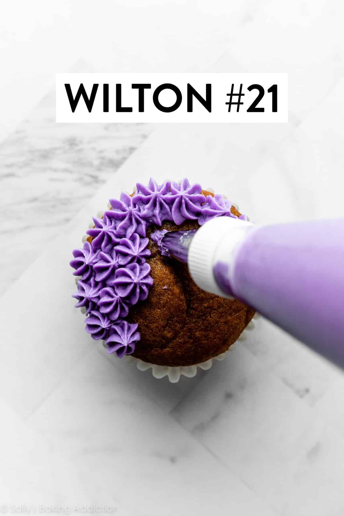 piping bag and tip piping purple frosting onto a cupcake.