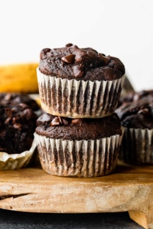 up close stack of 2 chocolate banana muffins.