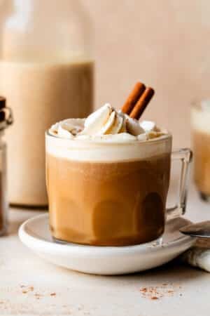 pumpkin coffee with whipped cream and cinnamon stick.