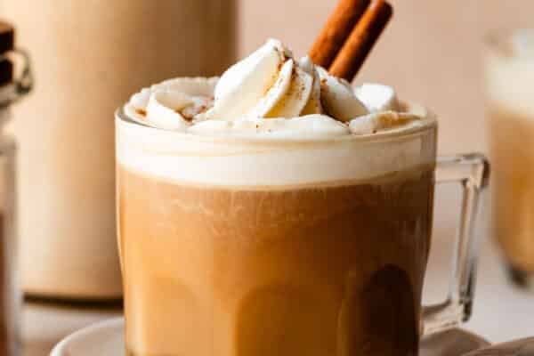 pumpkin coffee with whipped cream and cinnamon stick.