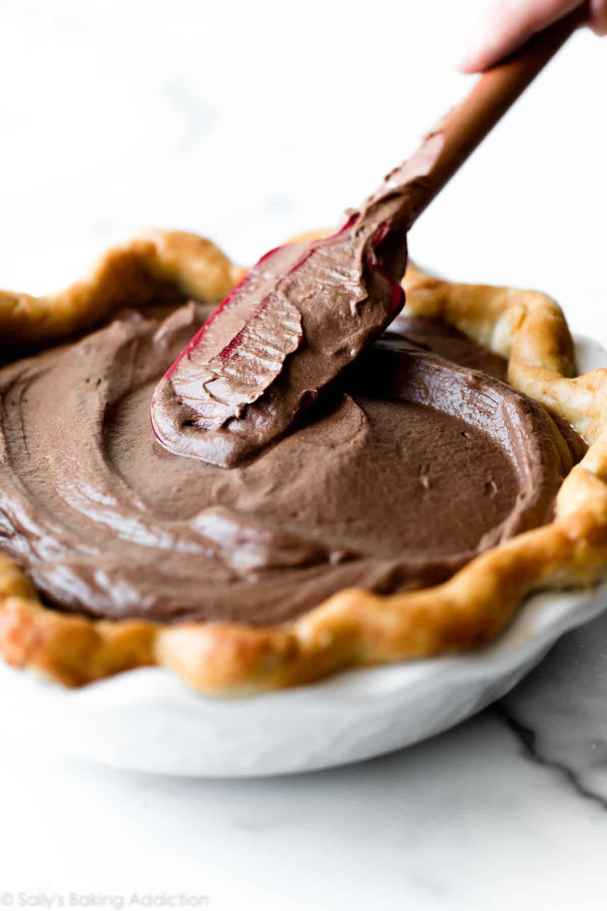 spreading French silk pie filling in pie crust