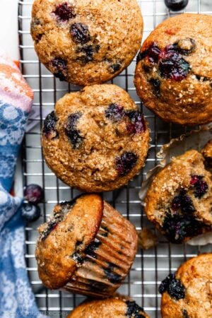 overhead photo of blueberry banana muffins on wire cooling rack.