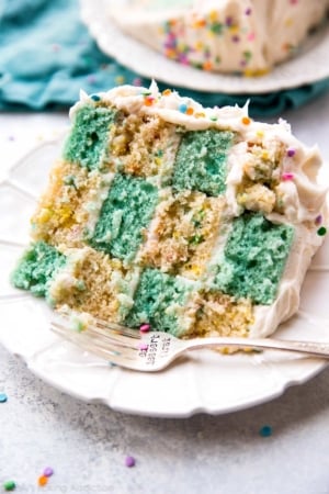 slice of checkerboard cake on a white plate with a fork