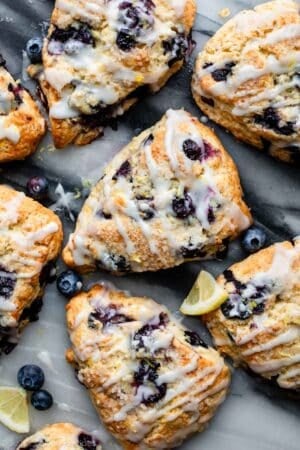 lemon blueberry scones with glaze on top.