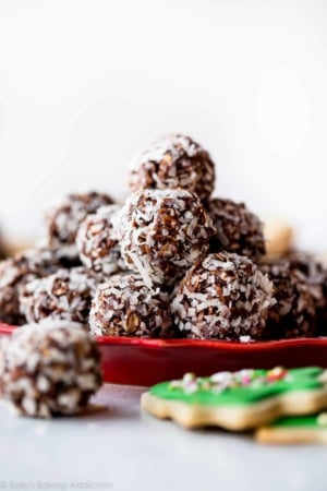 stack of no-bake chocolate coconut snowballs on a red plate