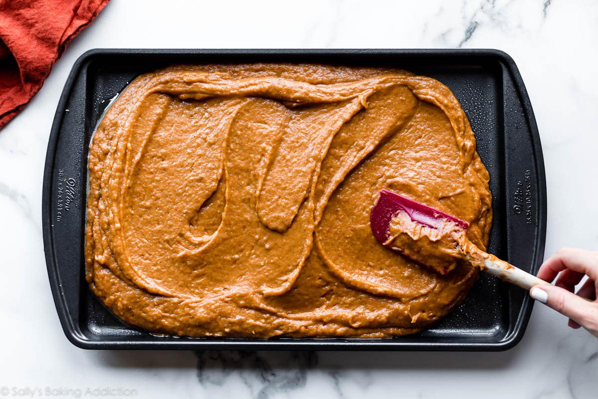 spreading pumpkin bars batter into baking pan