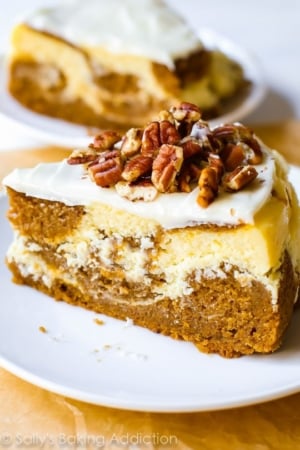 slice of pumpkin cake cheesecake on a white plate