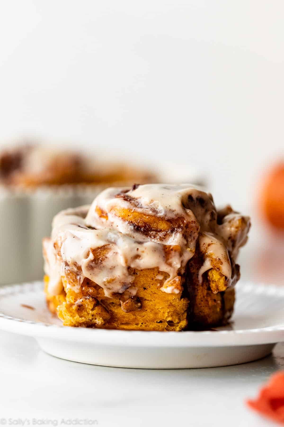 pumpkin cinnamon roll with maple cinnamon cream cheese icing