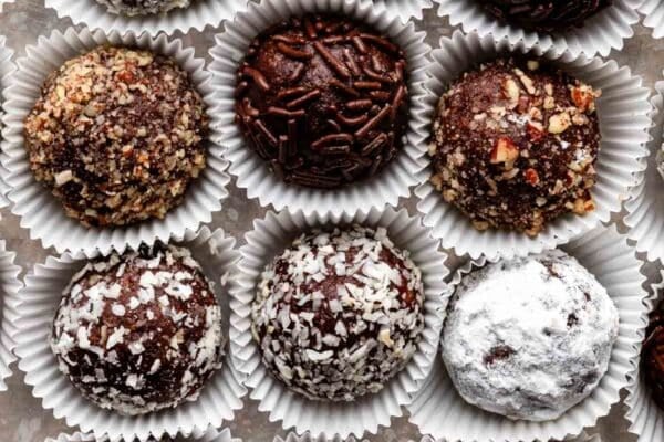 overhead close-up shot of rum balls coated in various toppings.