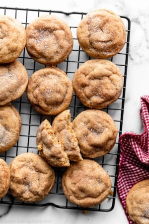 peanut butter snickerdoodles on black wire cooling rack.